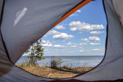 Scenic view of sea seen through tent