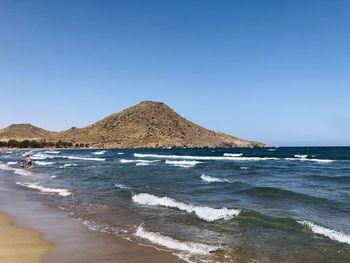 Scenic view of sea against clear blue sky