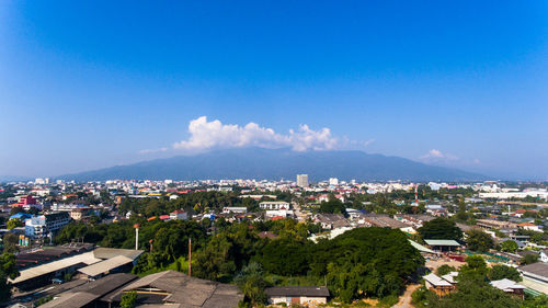 Cityscape against cloudy sky