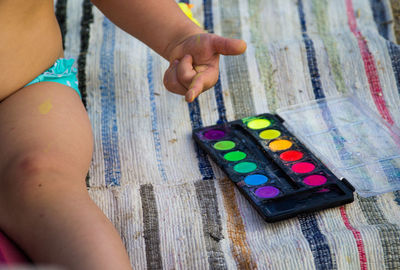 High angle view of hand holding painting