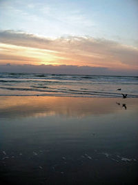 Scenic view of sea against sky at sunset