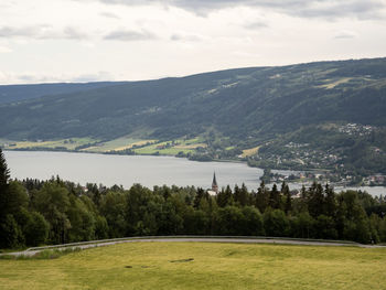 Scenic view of golf course against sky