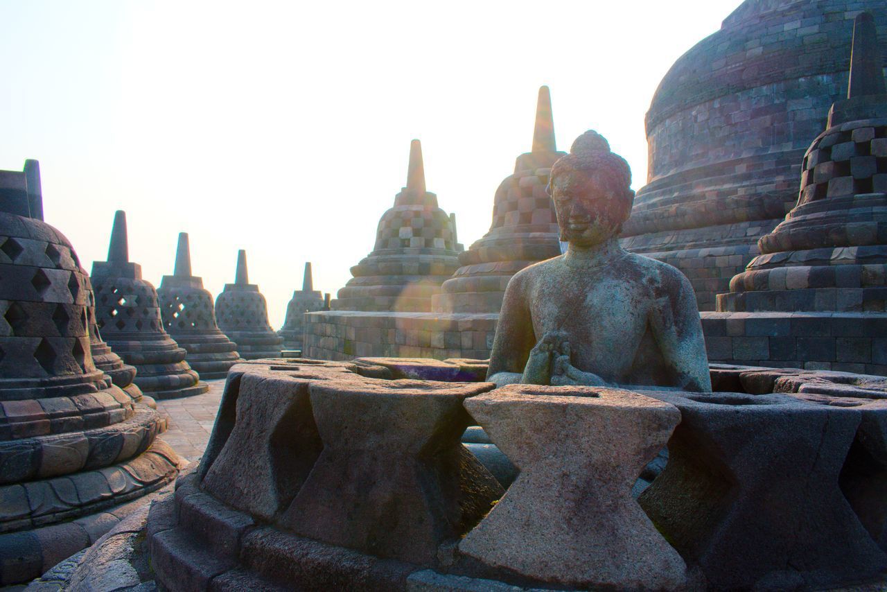 SCULPTURE OF TEMPLE AGAINST BUILDINGS