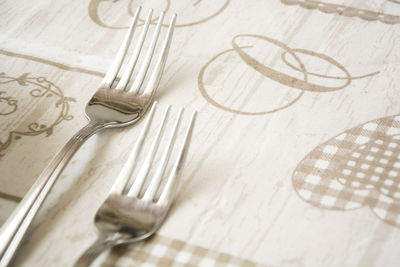 Close-up of forks on tablecloth