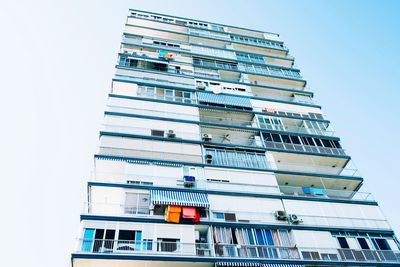 Low angle view of apartment building against clear sky