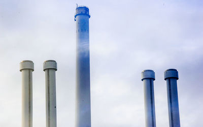 Low angle view of smoke stack against sky