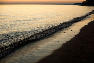 Scenic view of beach against sky during sunset