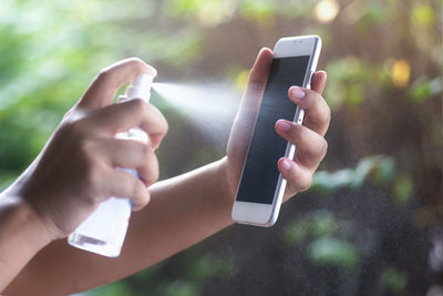 Midsection of man using mobile phone