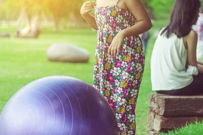 Low angle view of girl playing with balloons