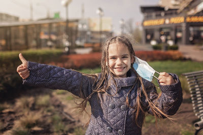 Portrait of smiling girl standing outdoors