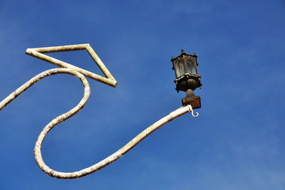 Low angle view of vapor trail against clear blue sky