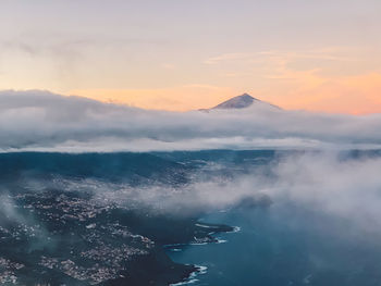 Scenic view of volcano and sea against sky