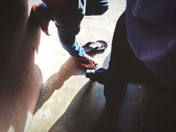 Low section of woman standing on tiled floor