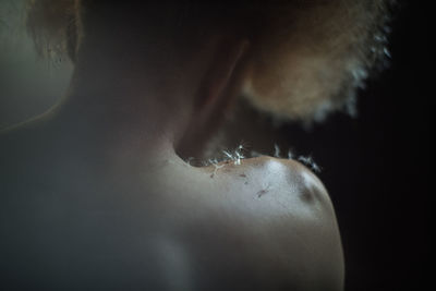 Close-up of man against black background