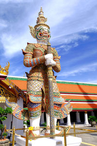 Low angle view of statue in temple against cloudy sky