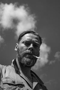 Low angle portrait of man against sky