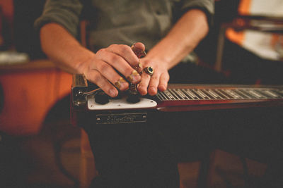 Close-up of man playing guitar