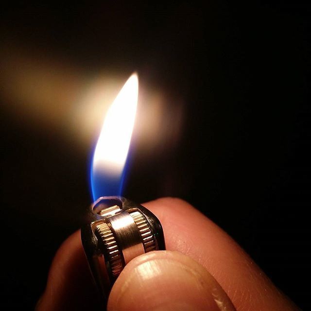 indoors, person, illuminated, one person, burning, glowing, close-up, flame, lighting equipment, part of, holding, candle, lit, human finger, heat - temperature, personal perspective, black background, electricity, cropped