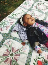 High angle view of baby lying on bed