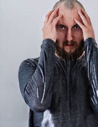 Portrait of man wearing mask against gray background