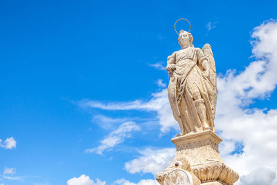 Low angle view of statue against cloudy sky