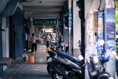 People on street amidst buildings in city