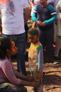 Rear view of people standing against multi colored