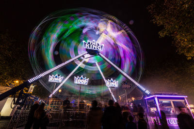 Low angle view of illuminated ferris wheel at night