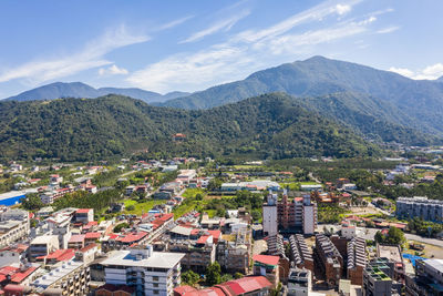 High angle view of townscape and mountains against sky