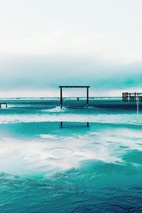 Scenic view of sea against cloudy sky