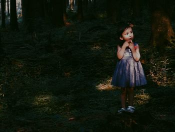 Cute girl standing in forest