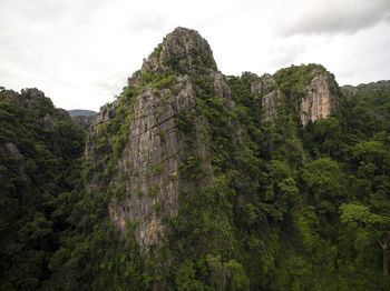 Low angle view of rocks on mountain against sky