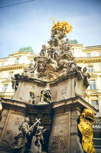 Low angle view of statue against historic building