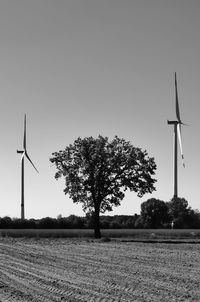 Windmill on field against clear sky