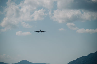 Low angle view of airplane flying in sky