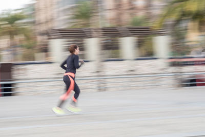 Blurred motion of man walking on road
