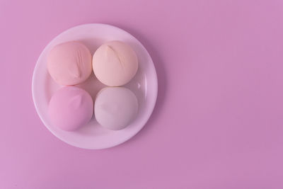 High angle view of pink eggs on white background