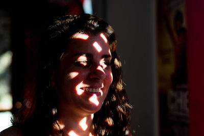 Close-up portrait of smiling young woman