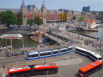 High angle view of vehicles on road along buildings