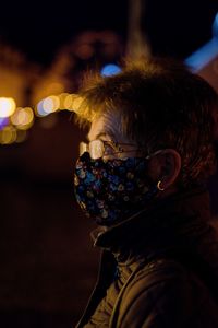 Close-up portrait of woman with illuminated light painting at night