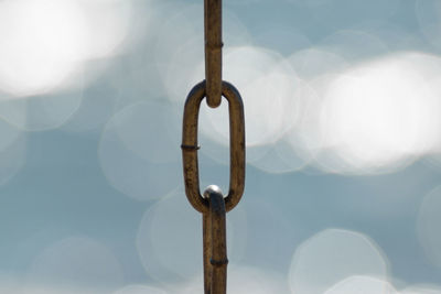 Close-up of chain against sky