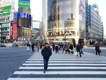 People crossing road in city