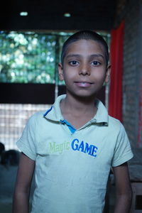 Portrait of smiling girl standing in corridor