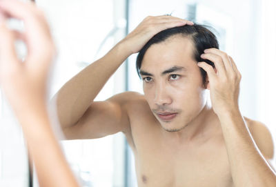 Portrait of young man in bathroom