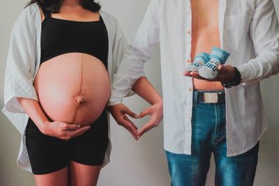 Midsection of couple holding hands