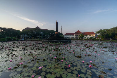 Scenic view of lake and buildings against sky