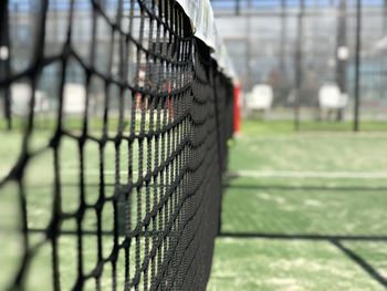 Close-up of soccer field seen through fence