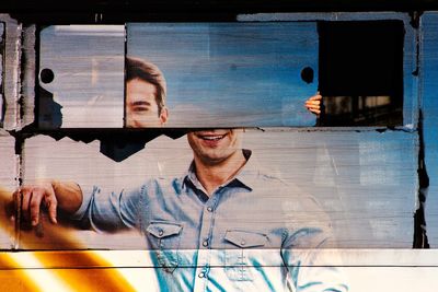 Portrait of man looking through window