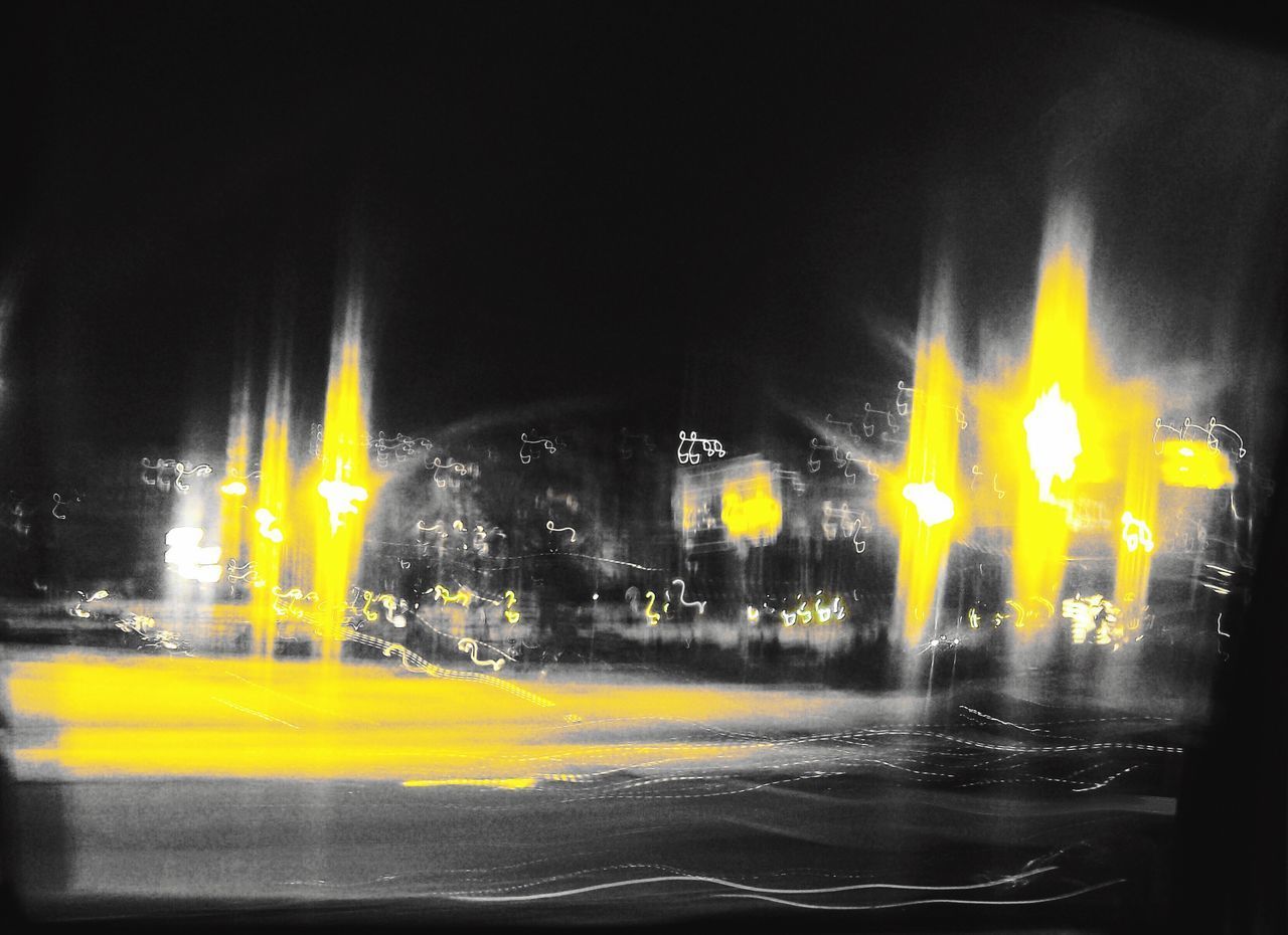 BLURRED MOTION OF YELLOW LIGHTS AT NIGHT