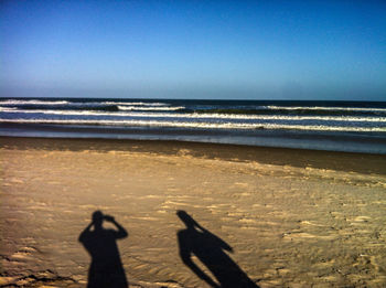 Scenic view of beach against clear sky